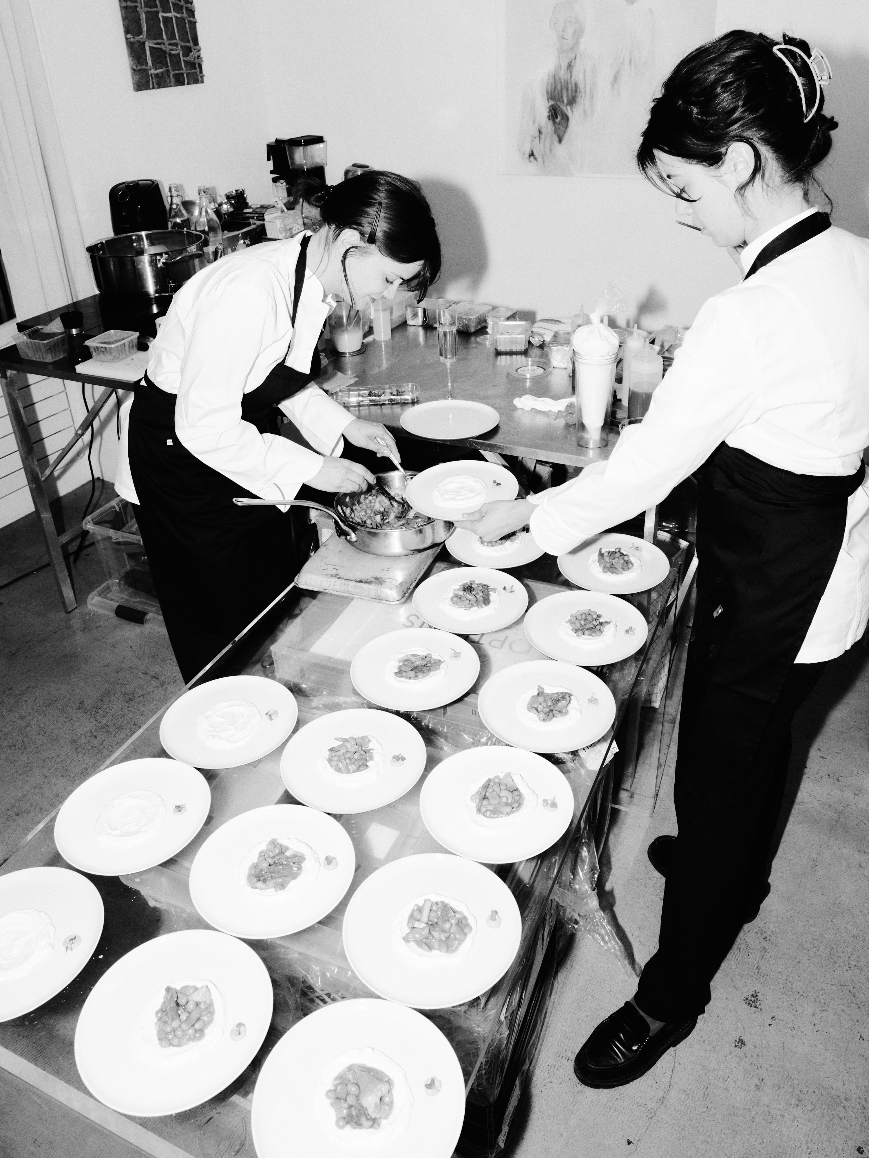 Emilie Fiastre and Camille Alix plating in the kitchen